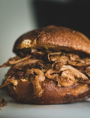 Close-up of a delicious pulled pork sandwich on a plate.