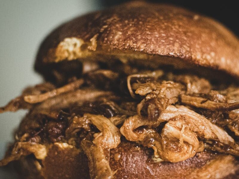 Close-up of a delicious pulled pork sandwich on a plate.